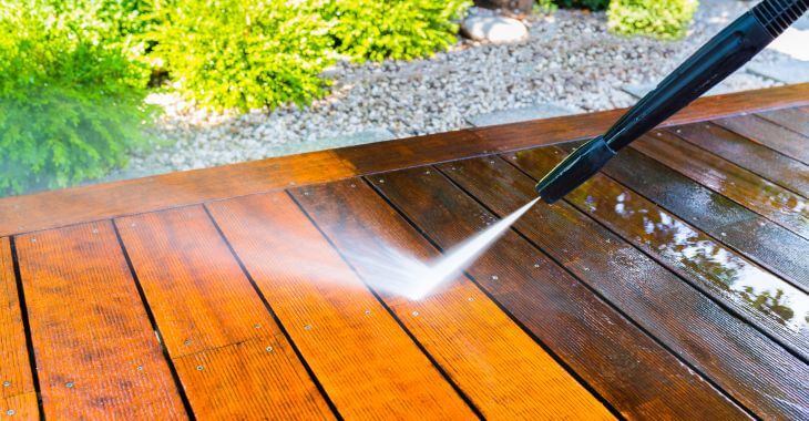 Cleaning composite decking with pressure washing.