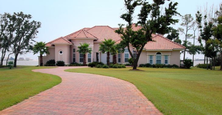 A residential house with a stone driveway.