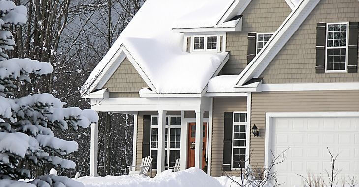 A residential hose with a snow cap on the roof.