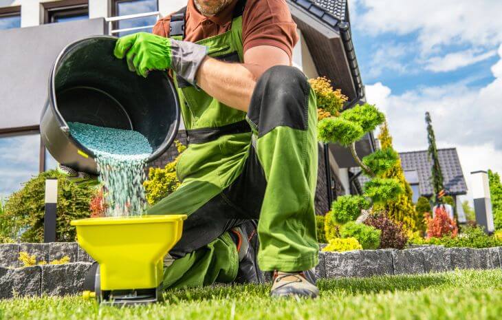 A landscaper preparing new sod fertilizer for use.