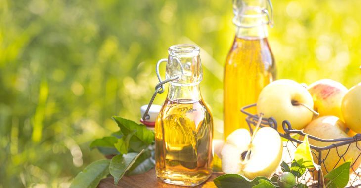 Bottles of vinegar on a table in the garden.