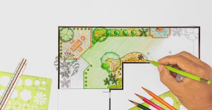 A person drawing garden landscape design blueprint.