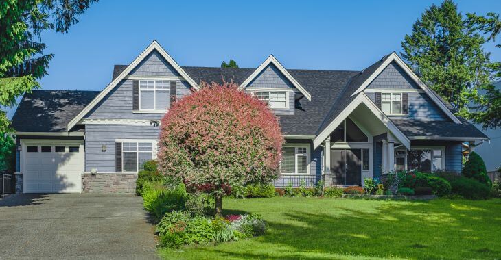 A lawn in front of a residential house.