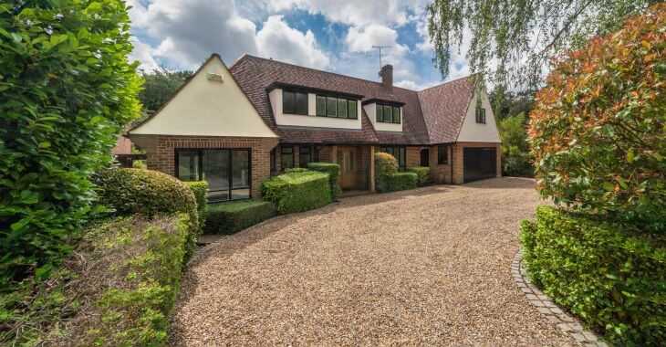 A detached house with road base gravel driveway in front