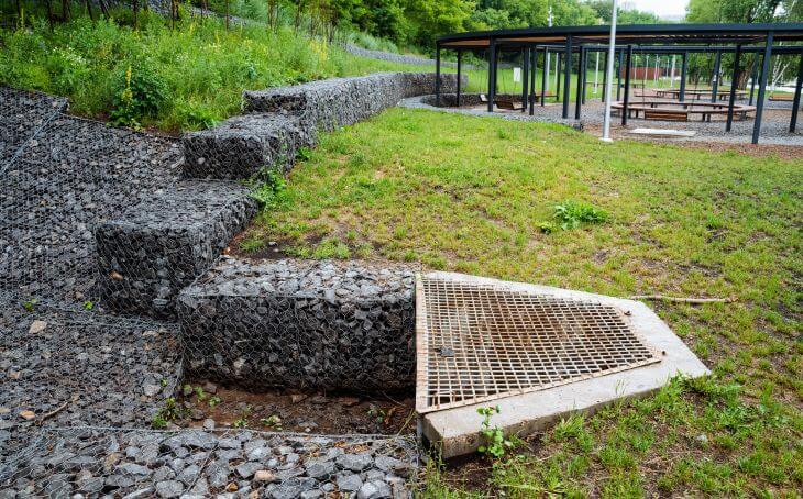 A recreational area with retaining walls and drainage solutions