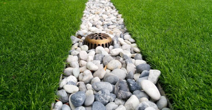 Manicured lush lawn with a french drain
